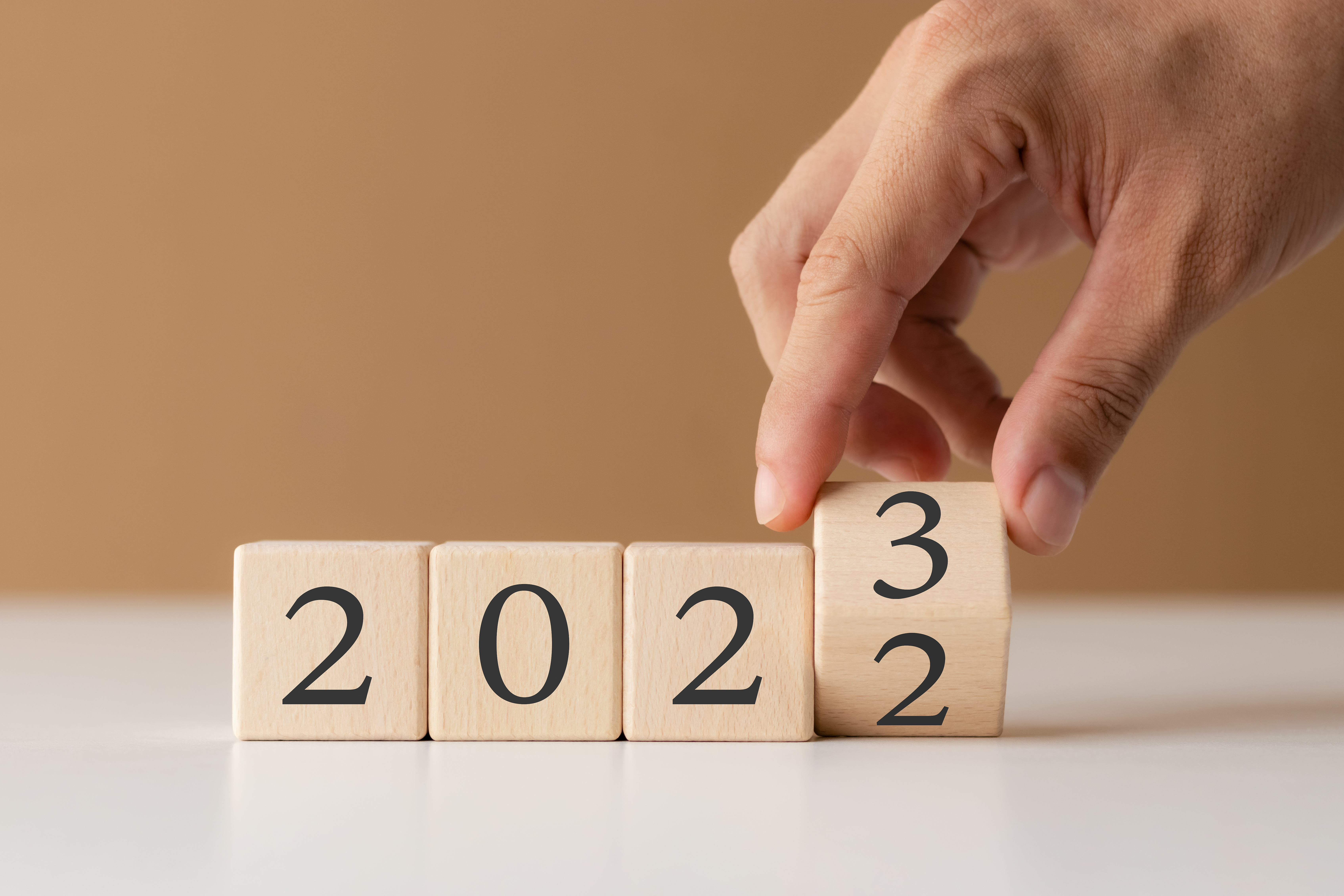 Individual arranging blocks to form the number 2023