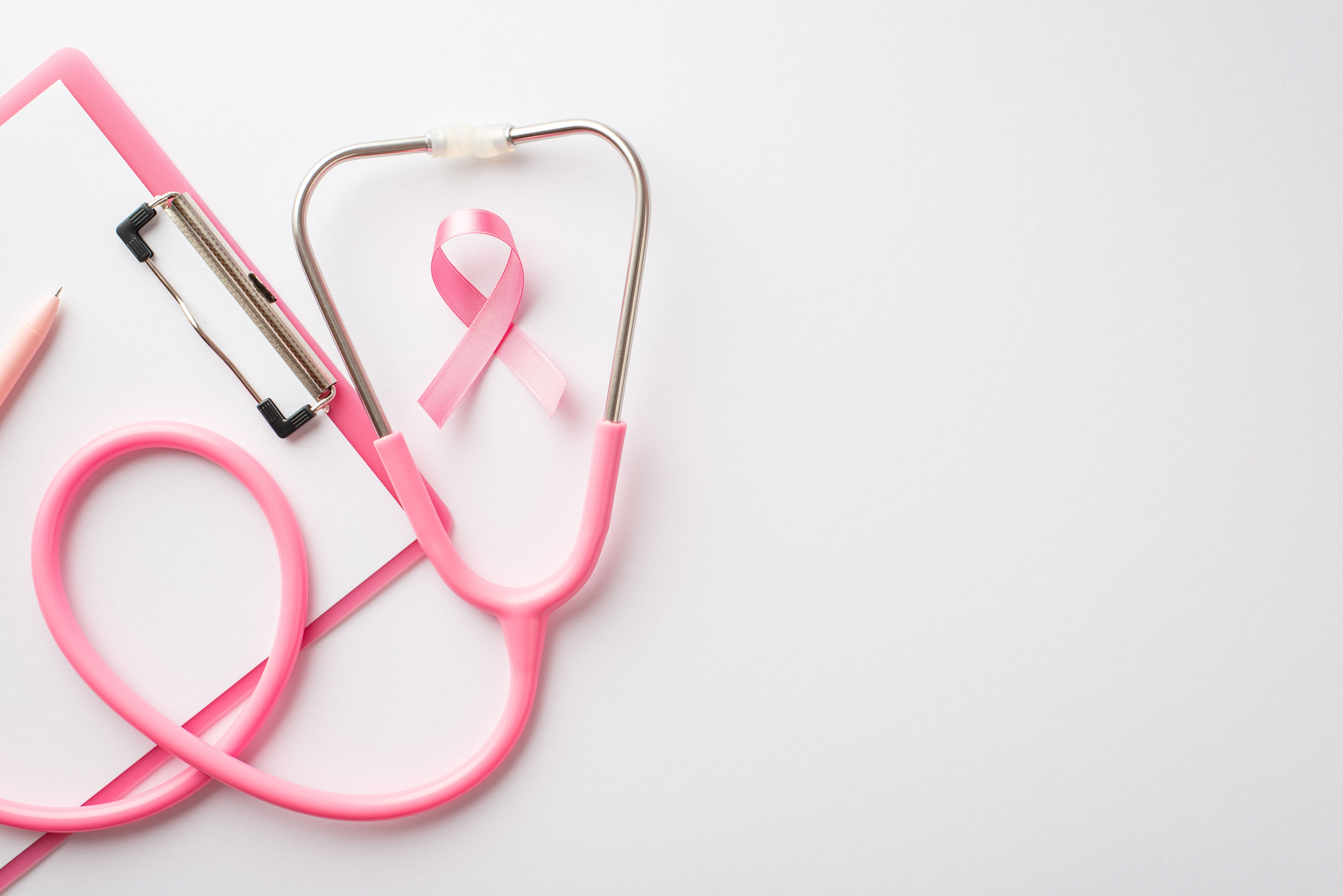 Pink stethoscope with a breast cancer awareness ribbon at its center, symbolizing healthcare's commitment to breast cancer screening improvements through Six Sigma methodology.